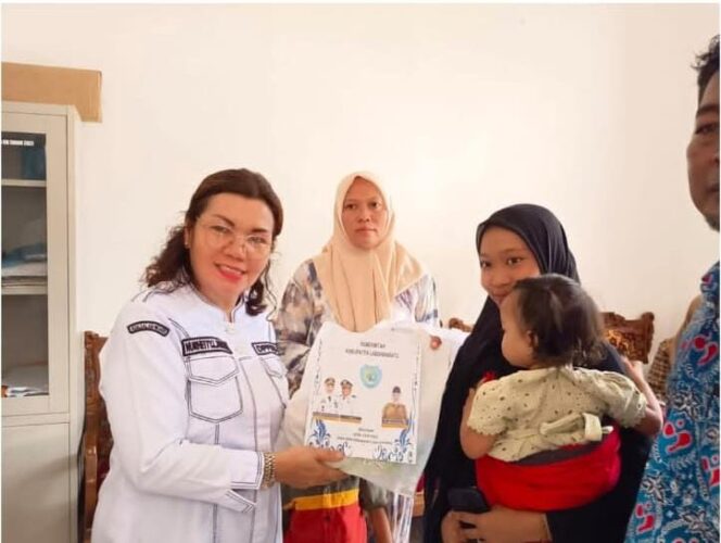 
					Pelaksana Tugas (Plt) Kepala Dinas Pengendalian Penduduk dan Keluarga Berencana (DPPKB) Labuhanbatu, Nurhetti Lumbantobing saat menyerahkan bantuan pangan